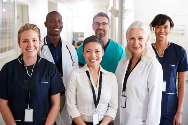 Portrait,of,medical,team,standing,in,hospital,corridor